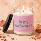 Jar candle with pink label reading "In my newlywed era. VOWED."