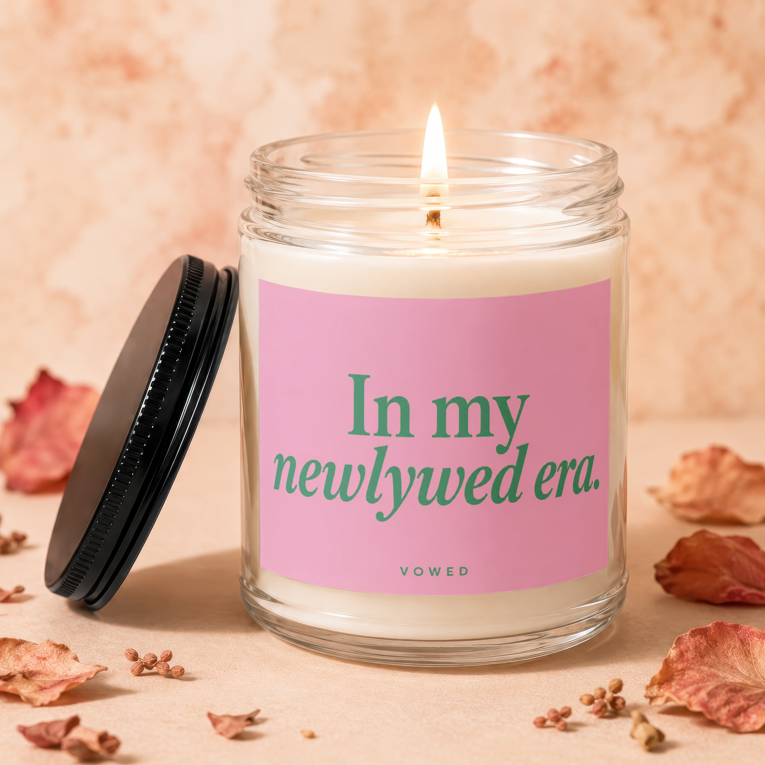 Jar candle with pink label reading "In my newlywed era. VOWED."