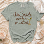 Green t-shirt with "this Bride needs a martini" text and martini glass graphic.