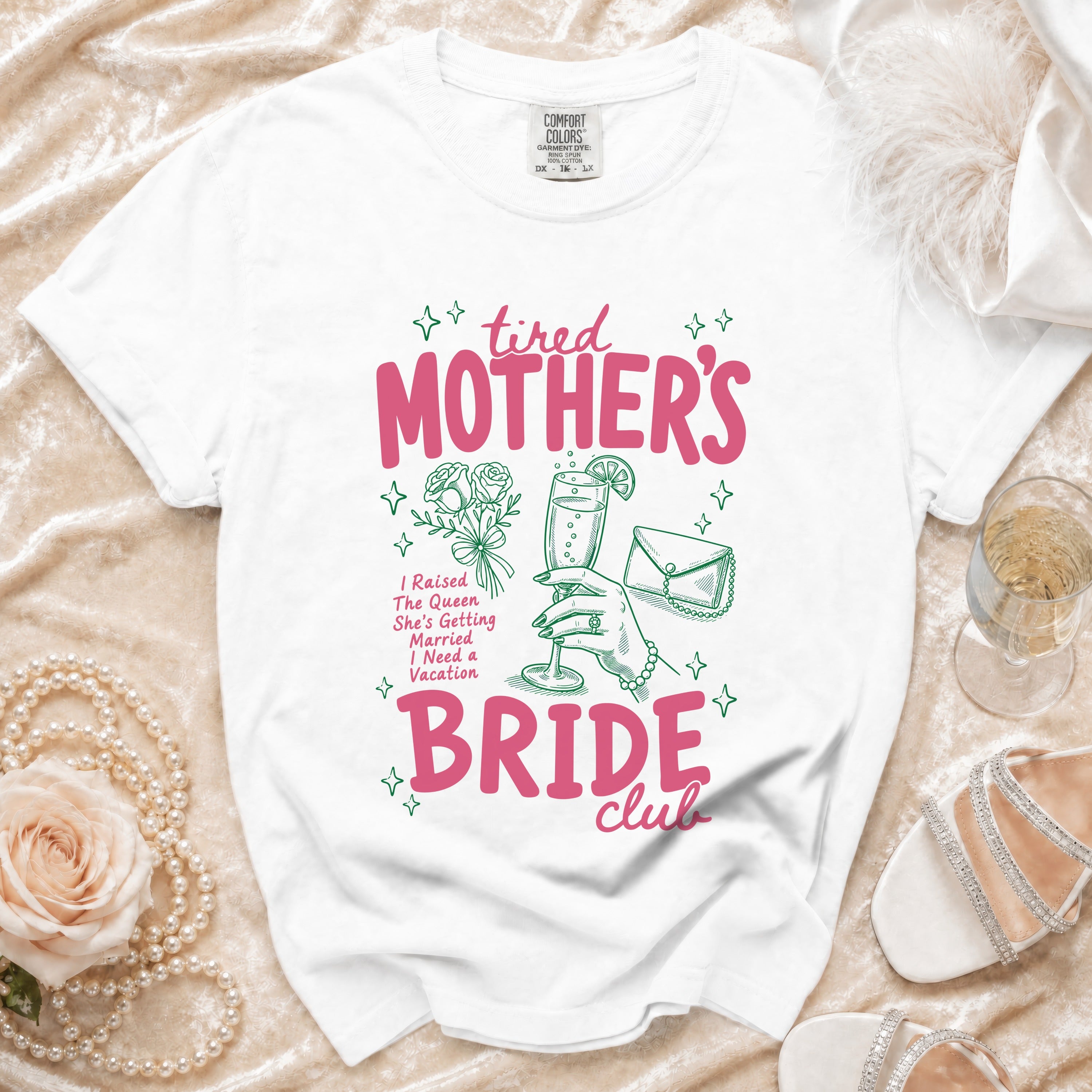 White t-shirt with "tired MOTHER'S BRIDE club" graphic and wedding-themed illustrations.