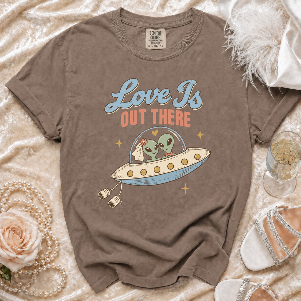 T-shirt graphic of aliens in a UFO with text "Love Is Out There".
