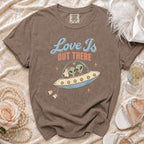 T-shirt graphic of aliens in a UFO with text "Love Is Out There".