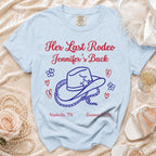Light blue t-shirt with "Her Last Rodeo Jennifer's Back" and cowboy hat graphic.