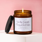 Amber glass candle with lit flame, inscribed with gratitude message to family.
