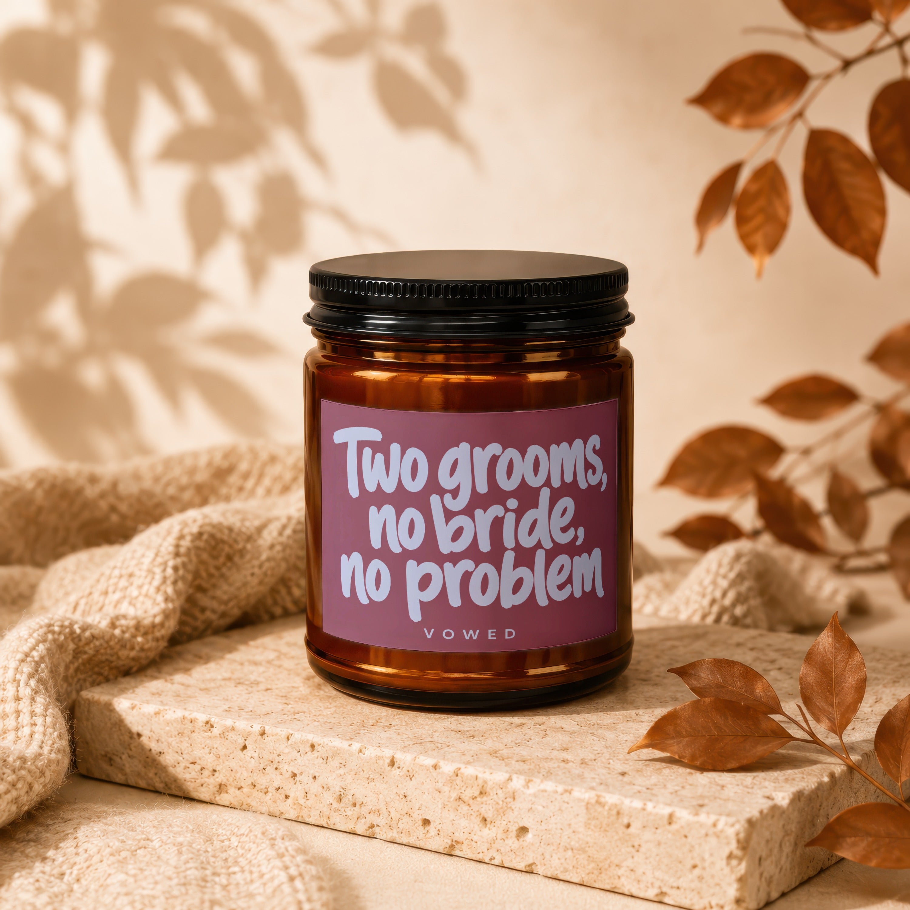 Amber jar candle with pink label reads "Two grooms, no bride, no problem" and "VOWED".