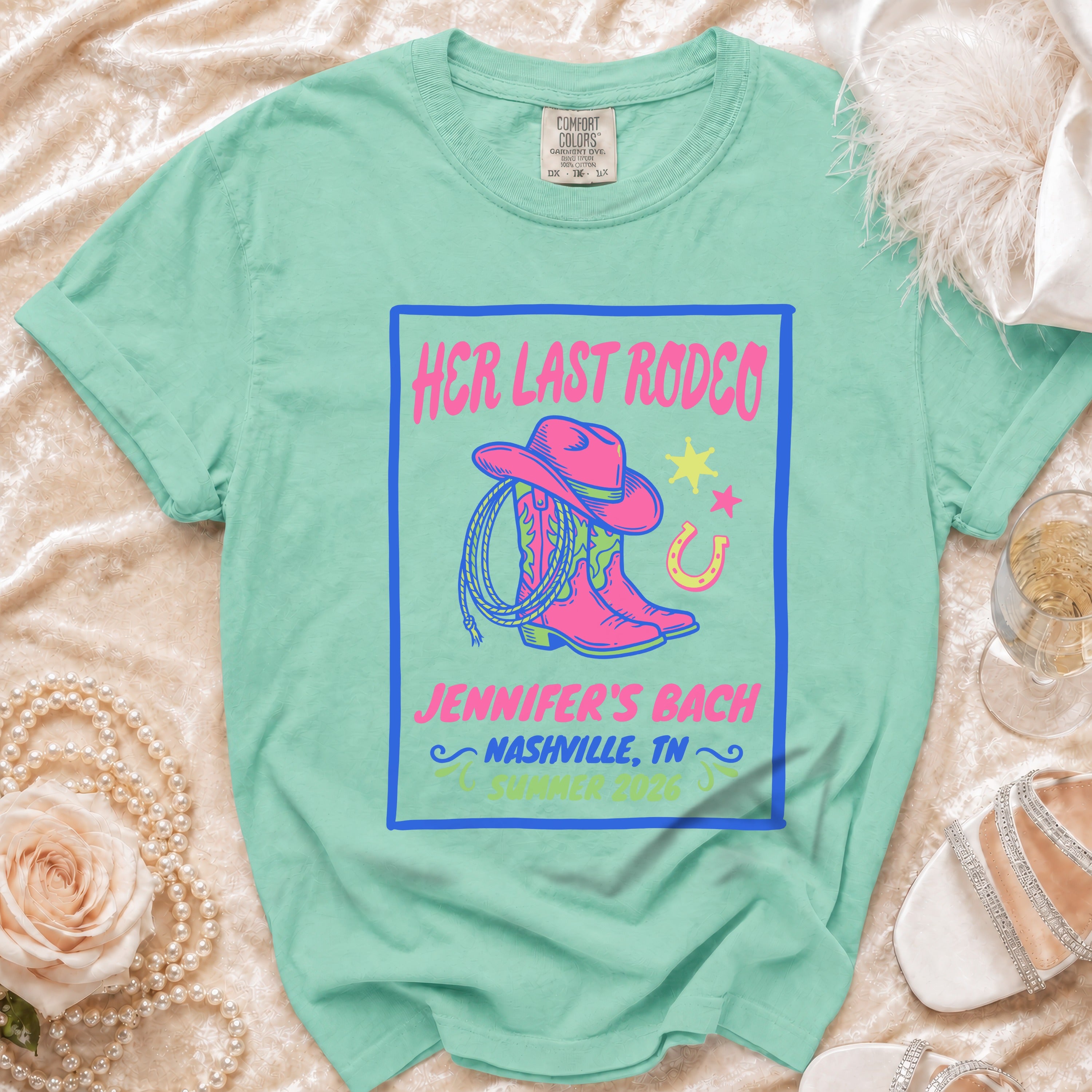Mint green t-shirt with "Her Last Rodeo" and rodeo graphics.