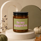 Amber candle with "In my engaged era. VOWED" text on light green label.