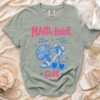 Maid of Honor Club t-shirt with pink text and blue graphics of a shoe, flowers, and heart sunglasses.