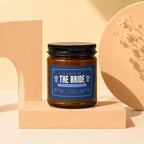 Brown candle with navy label reading "A Toast to The Bride. This Day is Yours."