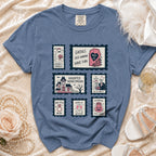 Blue t-shirt with six Halloween-themed wedding postage stamp graphics.
