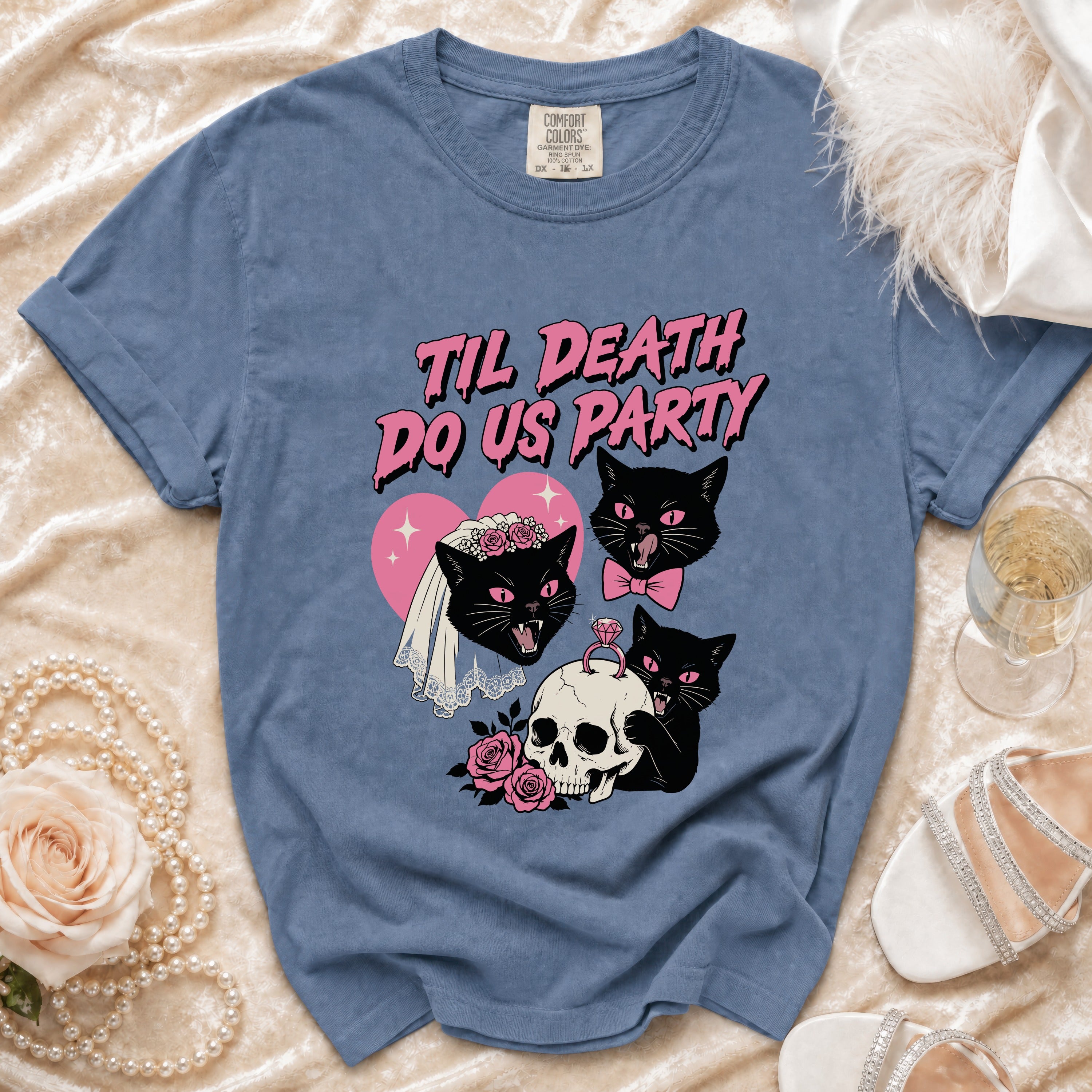 Blue t-shirt with "Til Death Do Us Party" text, black cats, skull, and roses graphic.