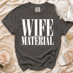 Dark grey t-shirt with "WIFE MATERIAL" printed in white.