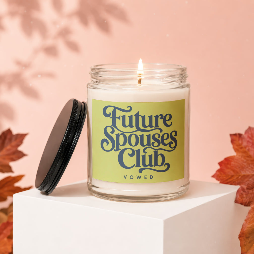Lit candle in a glass jar with "Future Spouses Club Vowed" text on label.
