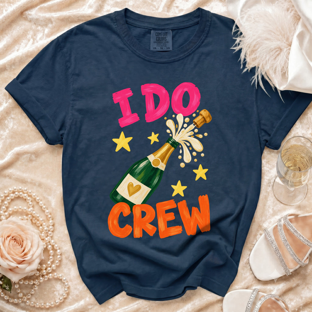 Navy t-shirt with "I DO CREW" text, champagne bottle, and stars graphic.