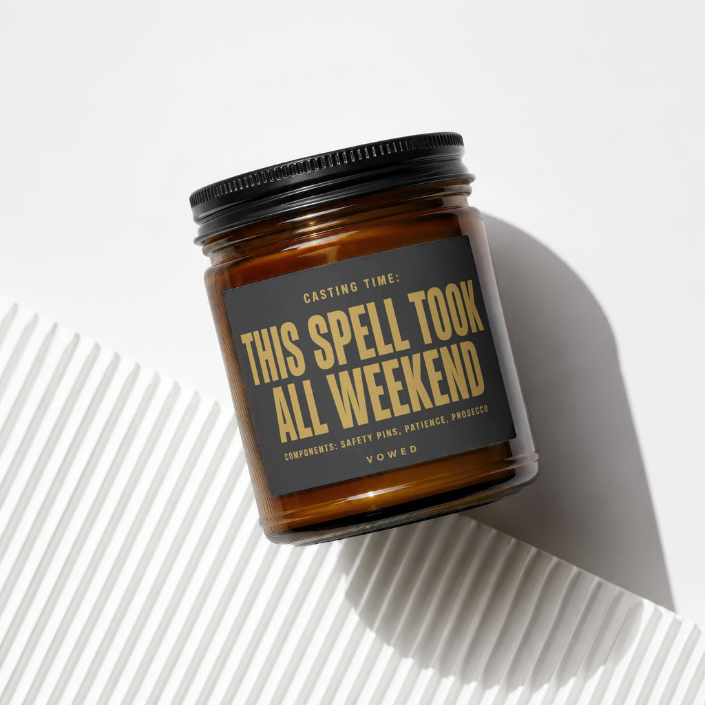 Amber candle in jar with black lid, labeled "THIS SPELL TOOK ALL WEEKEND".