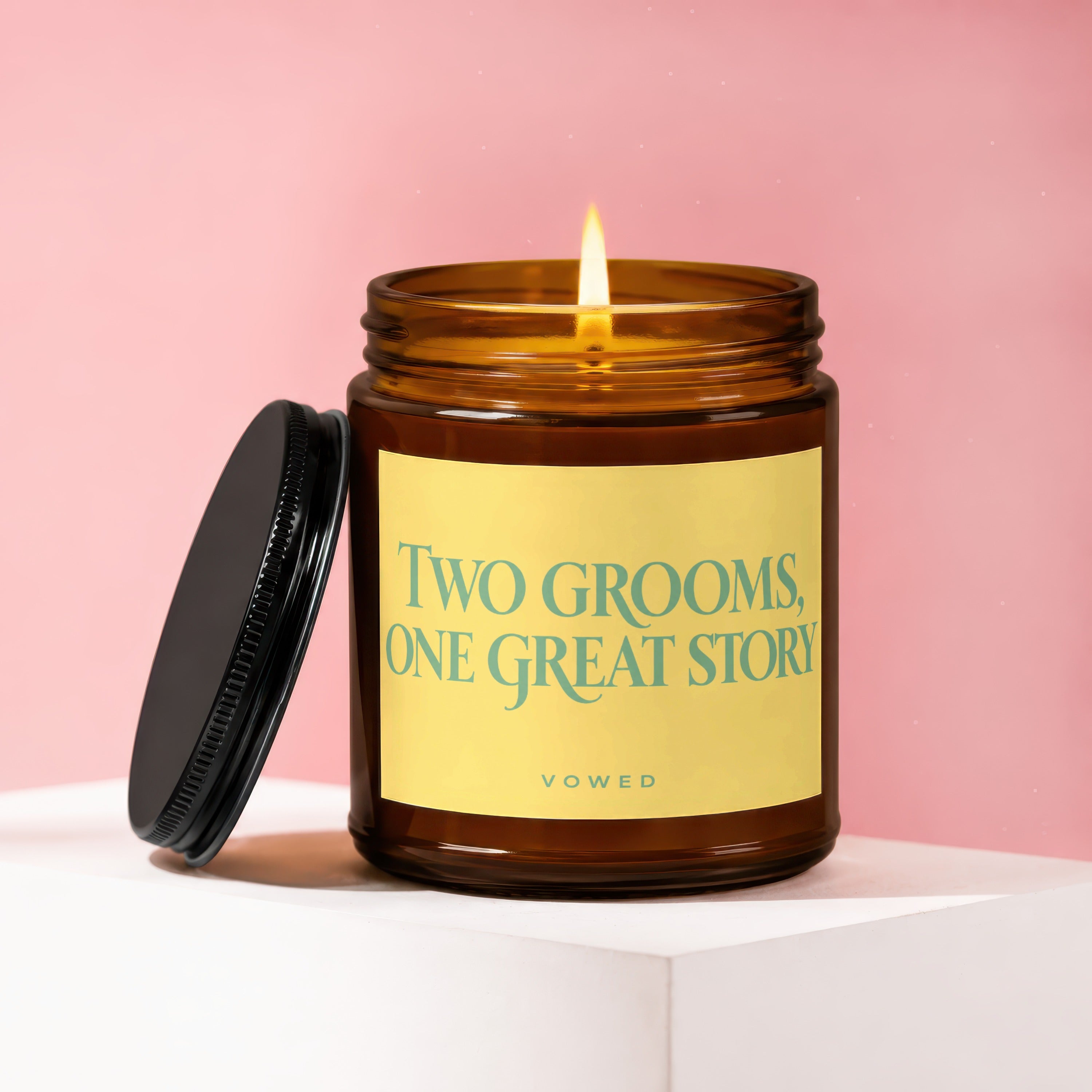 Candle with label "Two Grooms, One Great Story" on pink background.