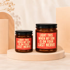 Two amber glass candles with black lids and red labels.