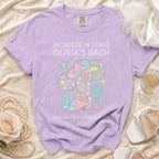Purple t-shirt with "Reckless in Texas Olivia's Bach" and cowboy theme graphic.