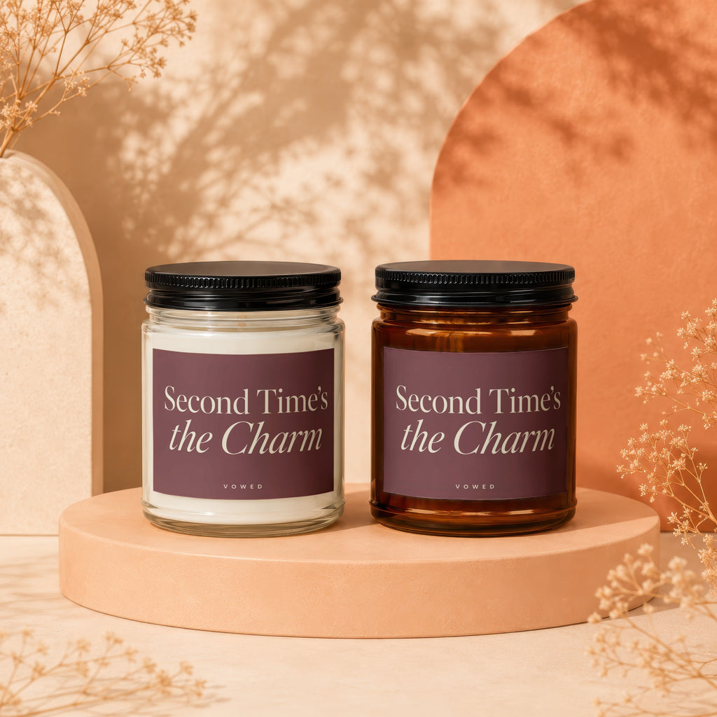 Two glass candles labeled "Second Time's the Charm" by Vowed.