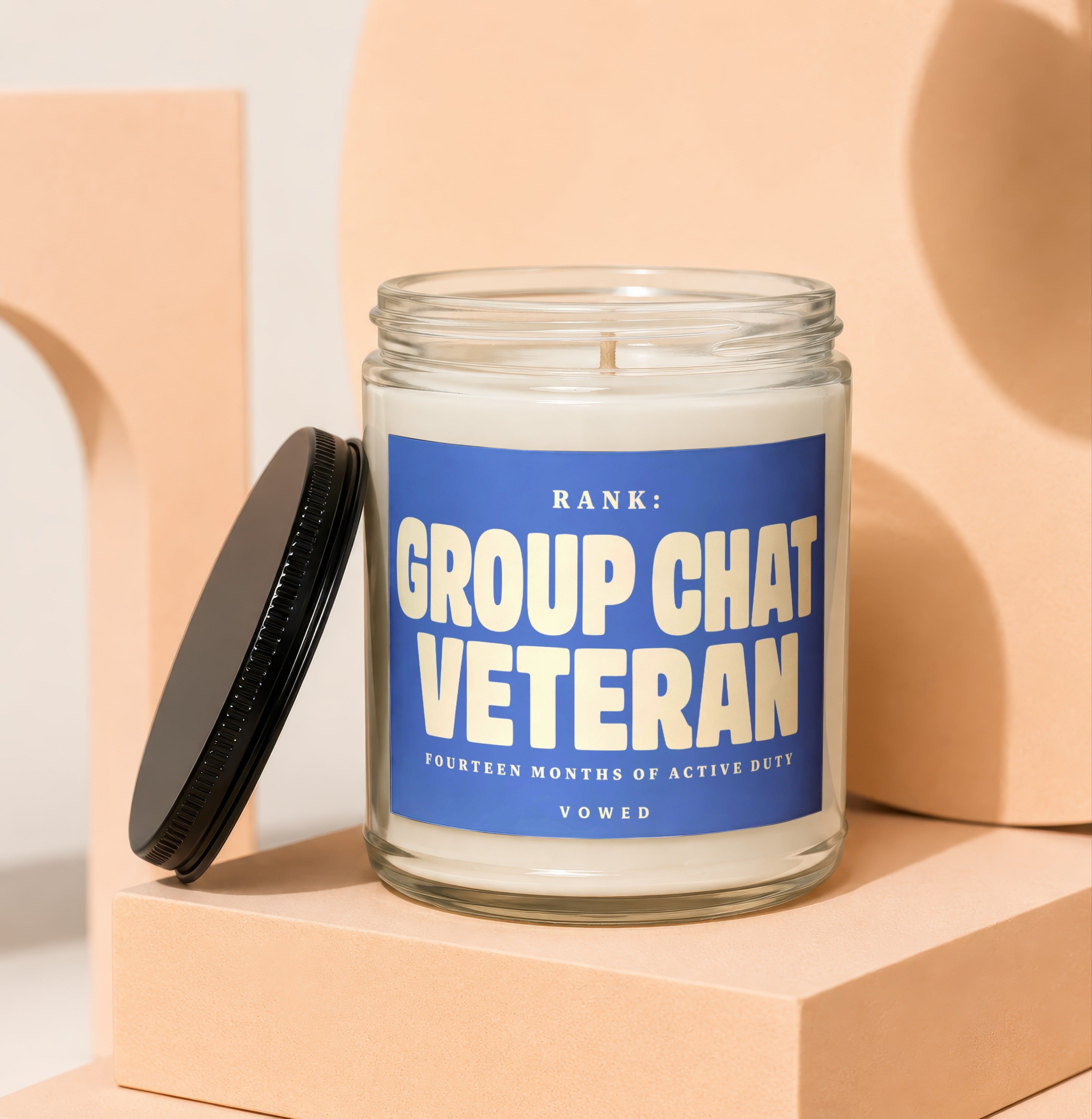 Glass jar candle with blue label that reads "Rank: Group Chat Veteran" and "Vowed".