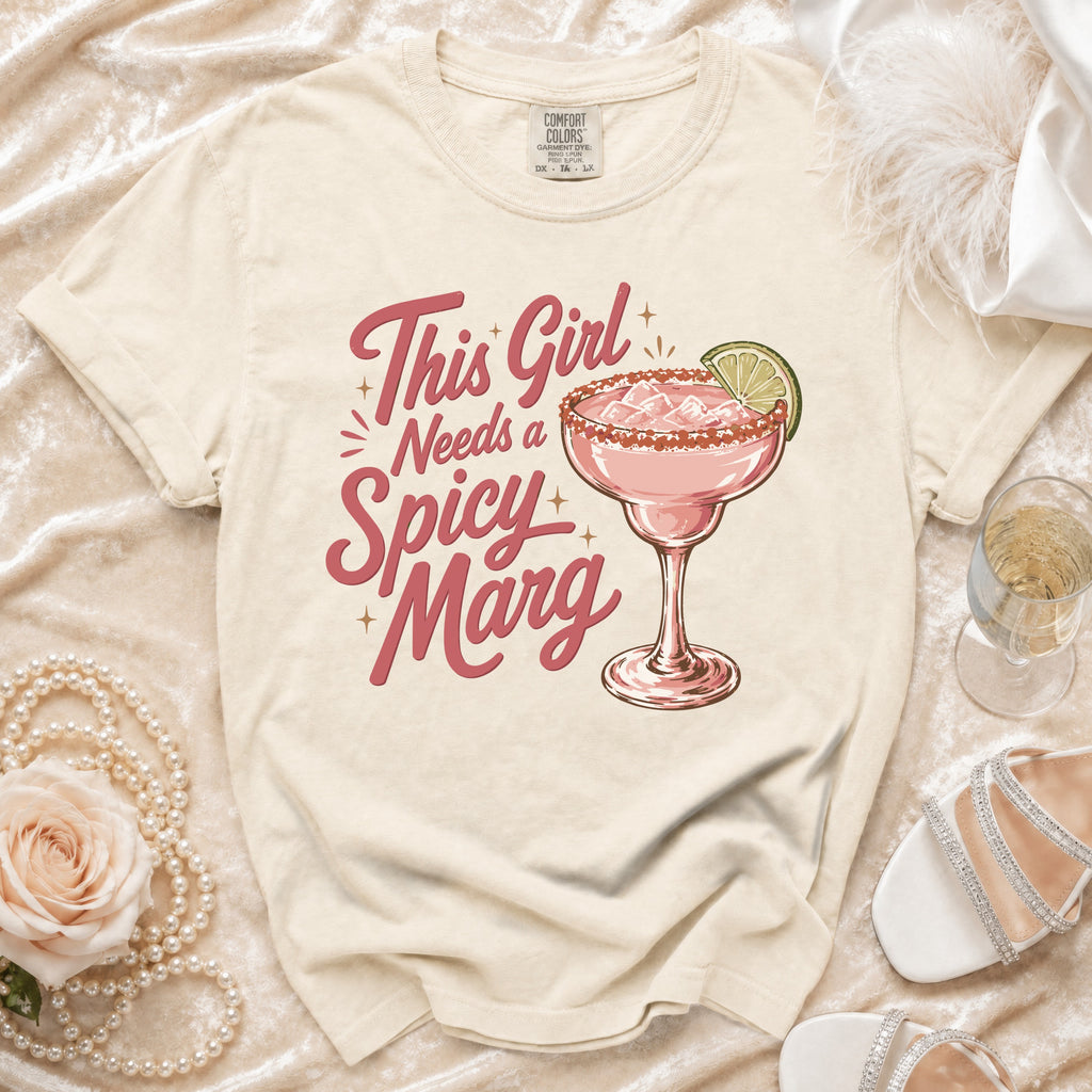 Cream t-shirt with "This Girl Needs a Spicy Marg" text and a margarita.