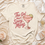 Cream t-shirt with "This Girl Needs a Spicy Marg" text and a margarita.