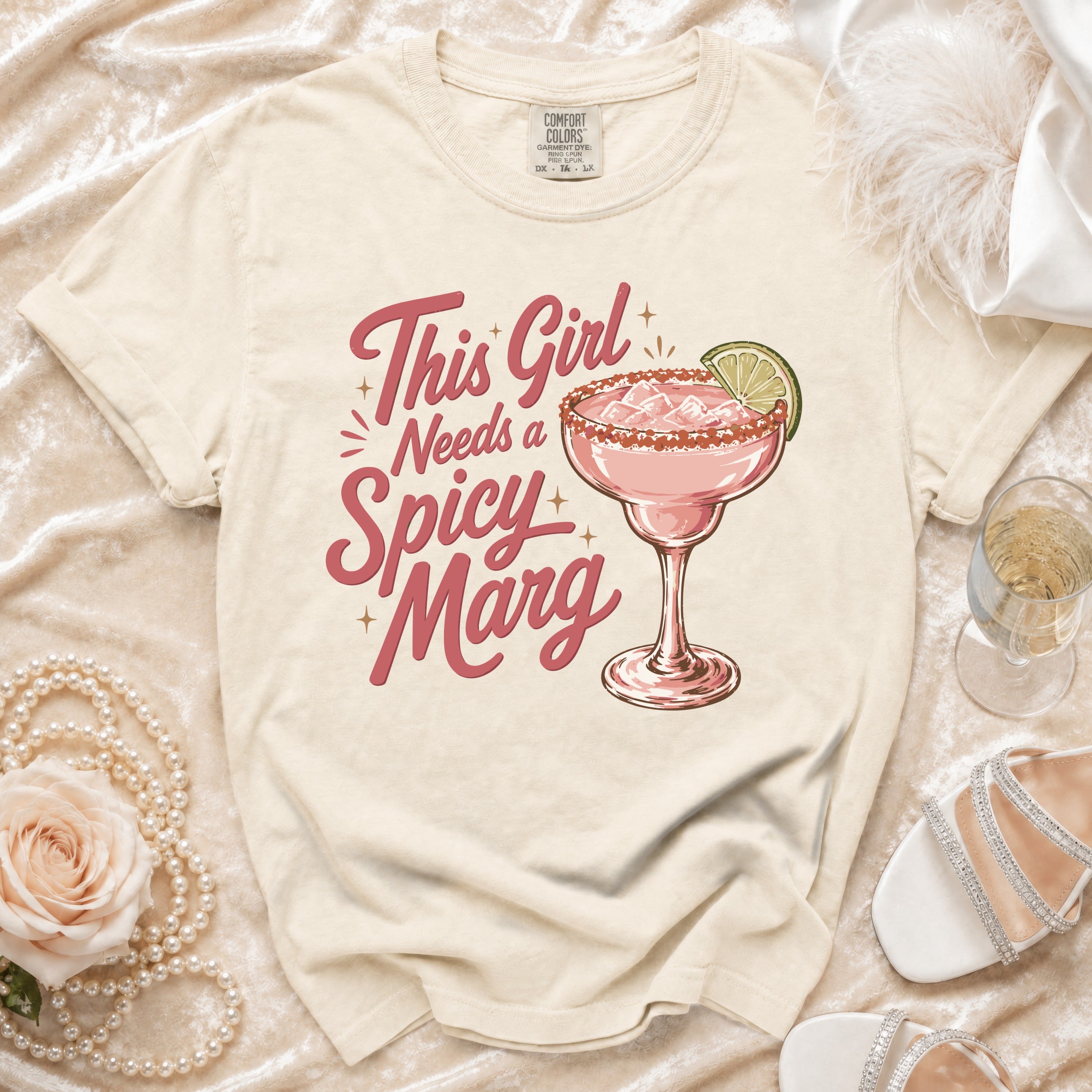 Cream t-shirt with "This Girl Needs a Spicy Marg" text and a margarita.