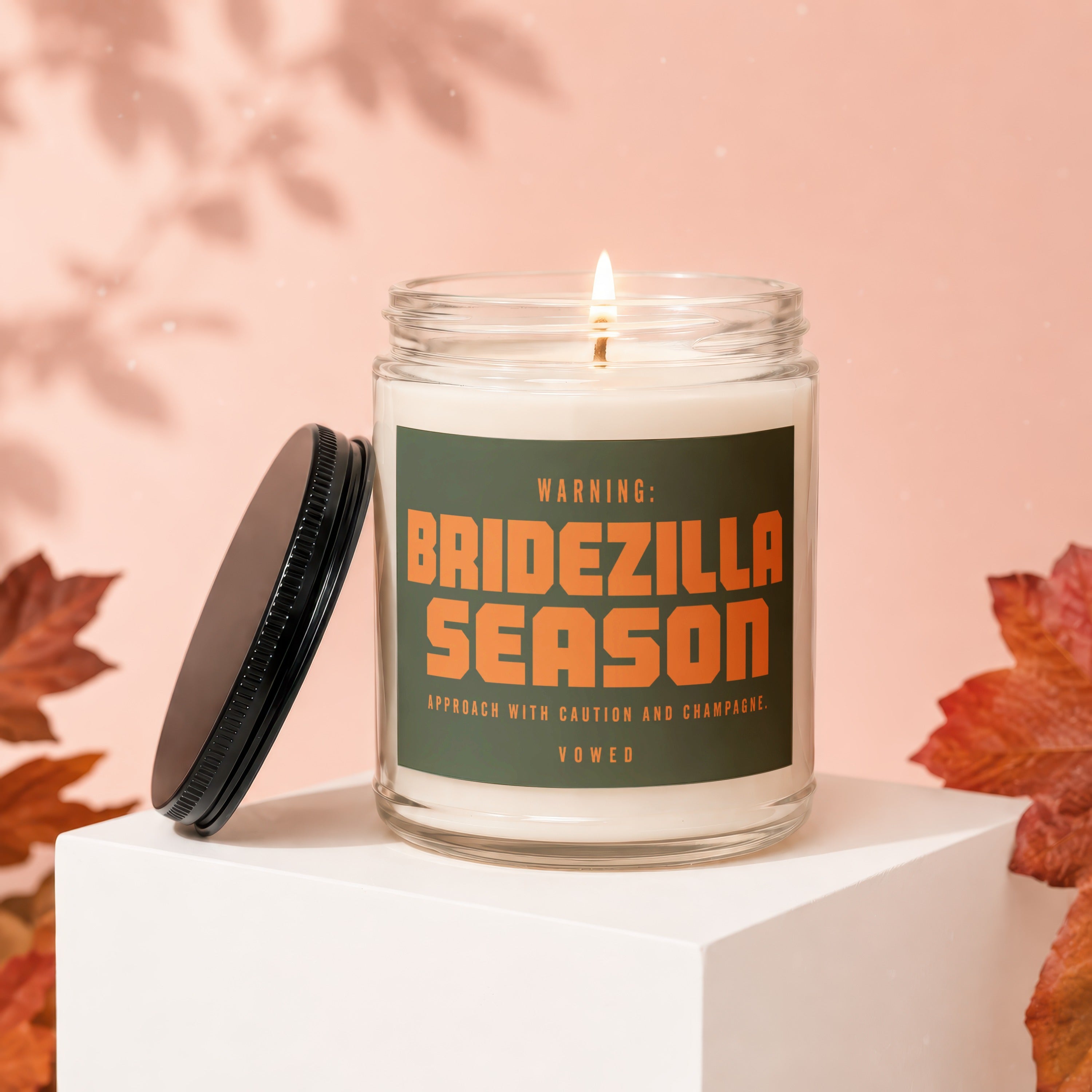 Candle with "BRIDEZILLA SEASON" text on label, lid off.