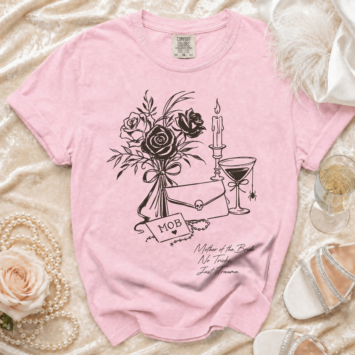 Pink t-shirt with "MOB" and "Mother of the Bride No Tricks Just Trauma" text.