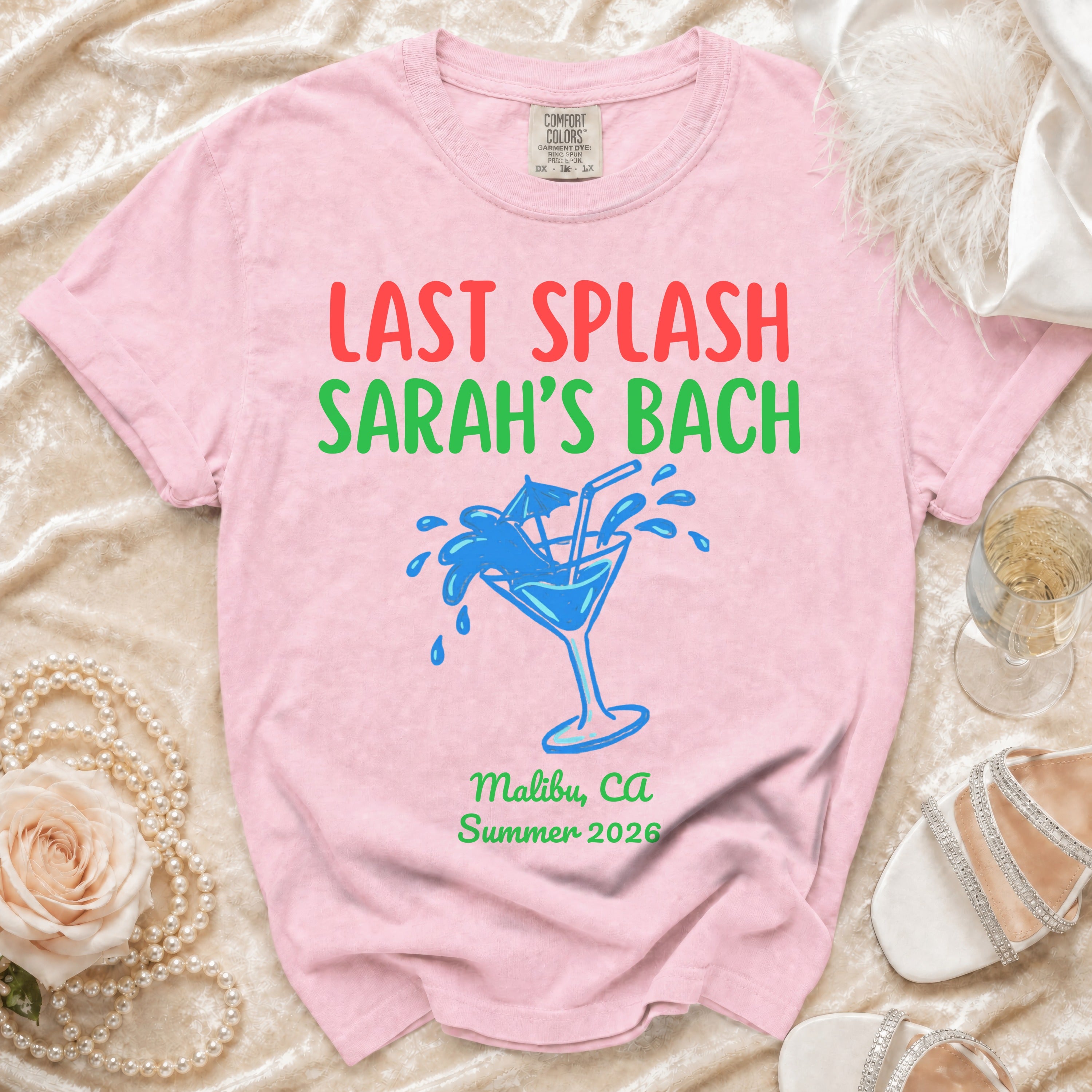 Pink t-shirt with "Last Splash Sarah's Bach" and cocktail graphic.