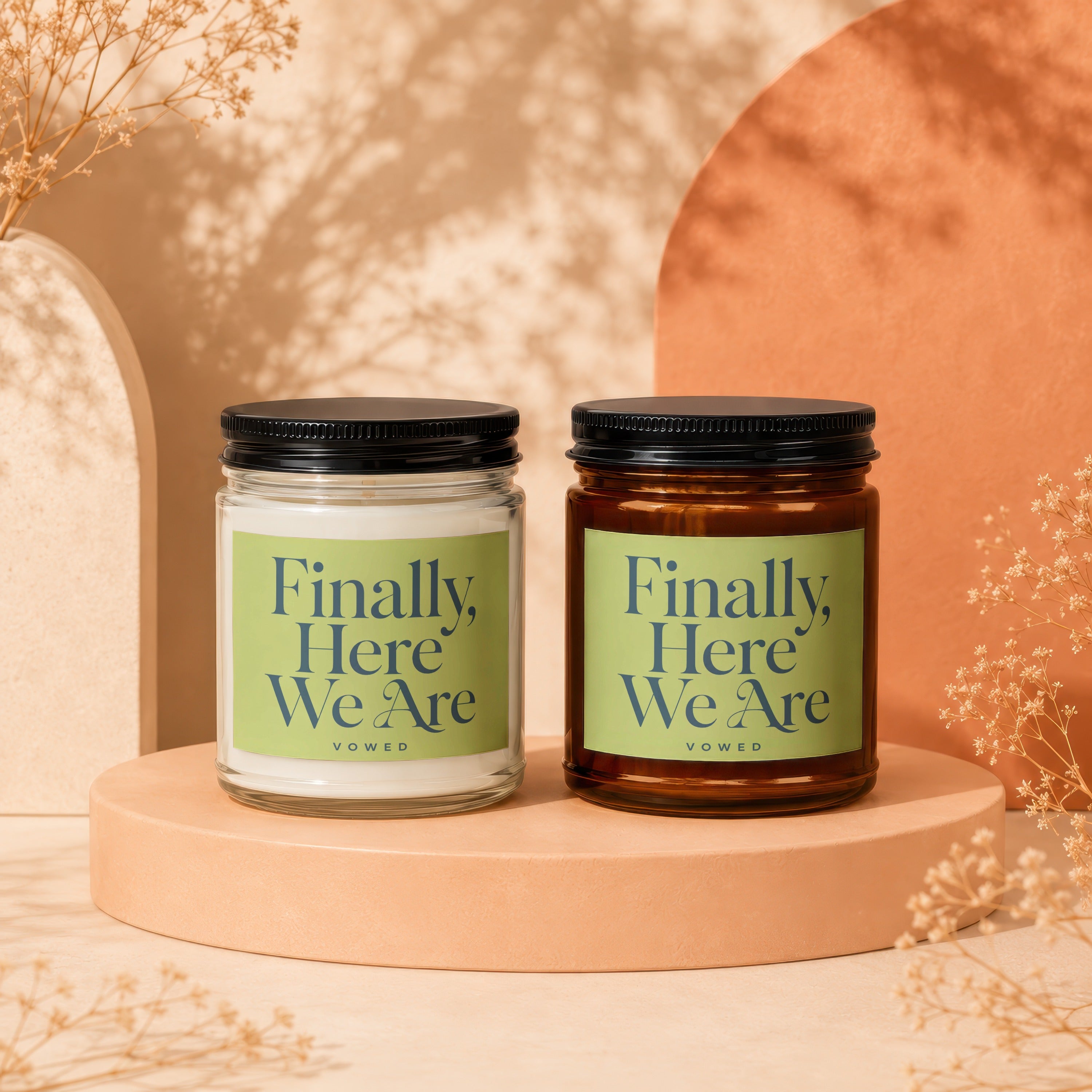 Two candles for "Finally, Here We Are" by Vowed on display pedestals.
