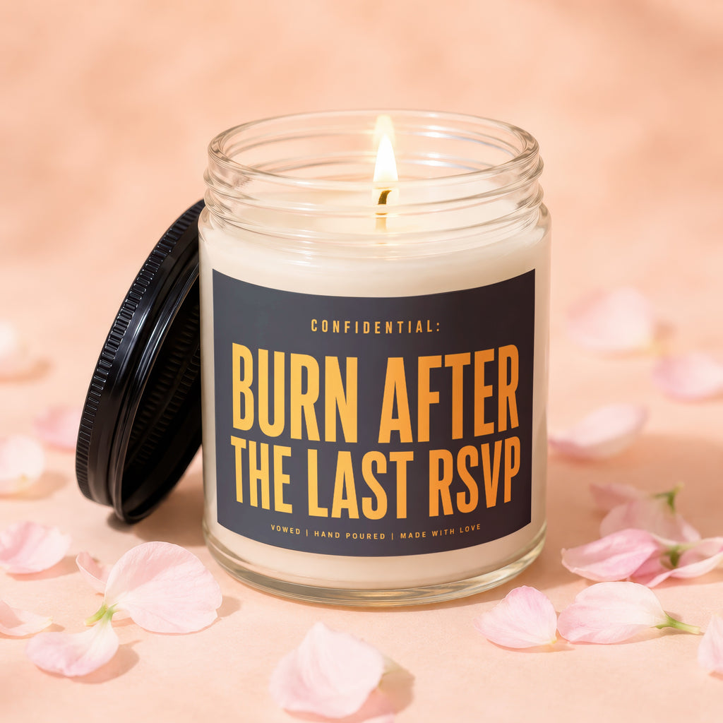 Glass candle with lid off, lit wick, and text "Burn After The Last RSVP".