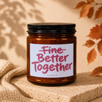 Amber jar candle with "Fine Better Together" text and a knitted fabric accent.