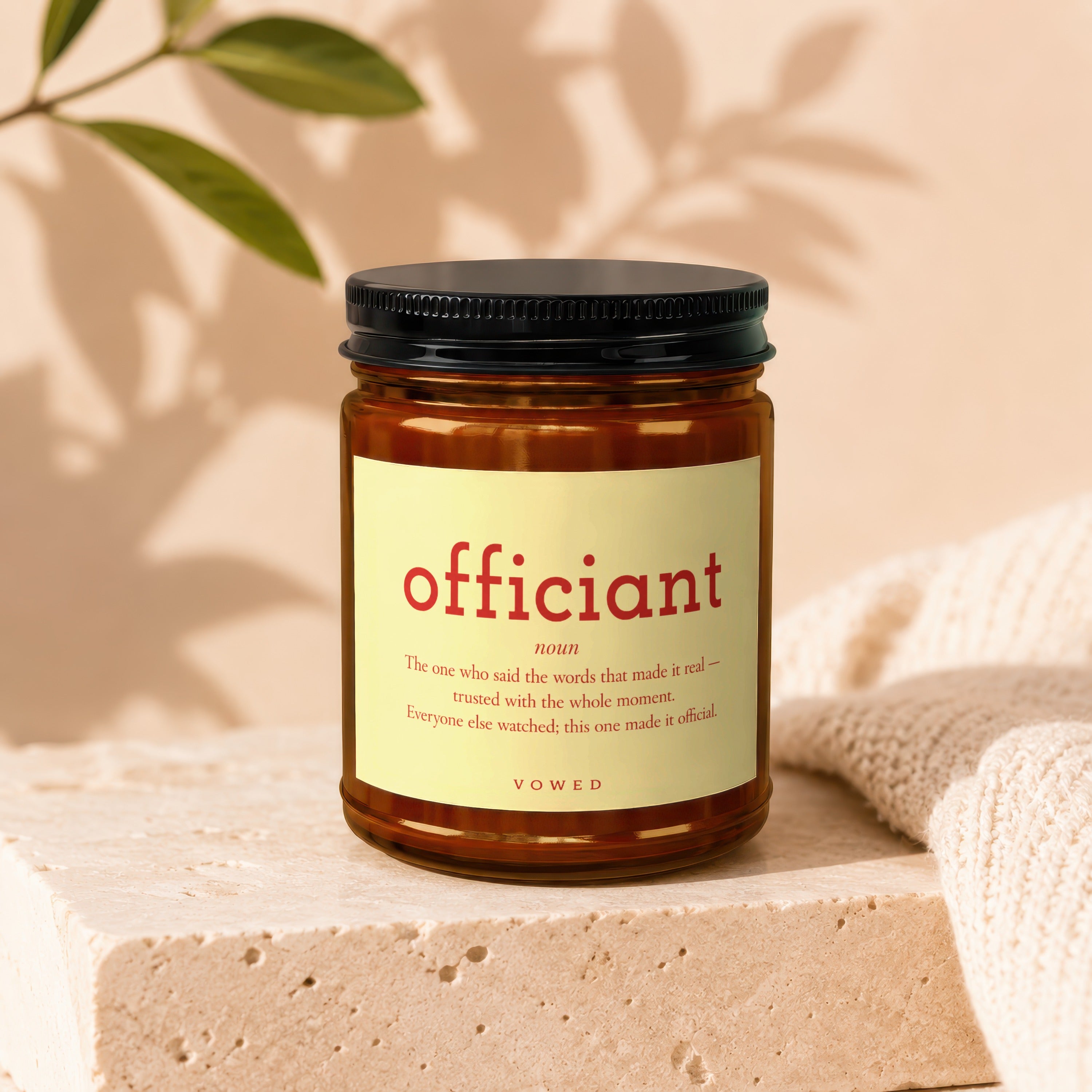 Amber jar candle with "officiant" definition and "VOWED" label.