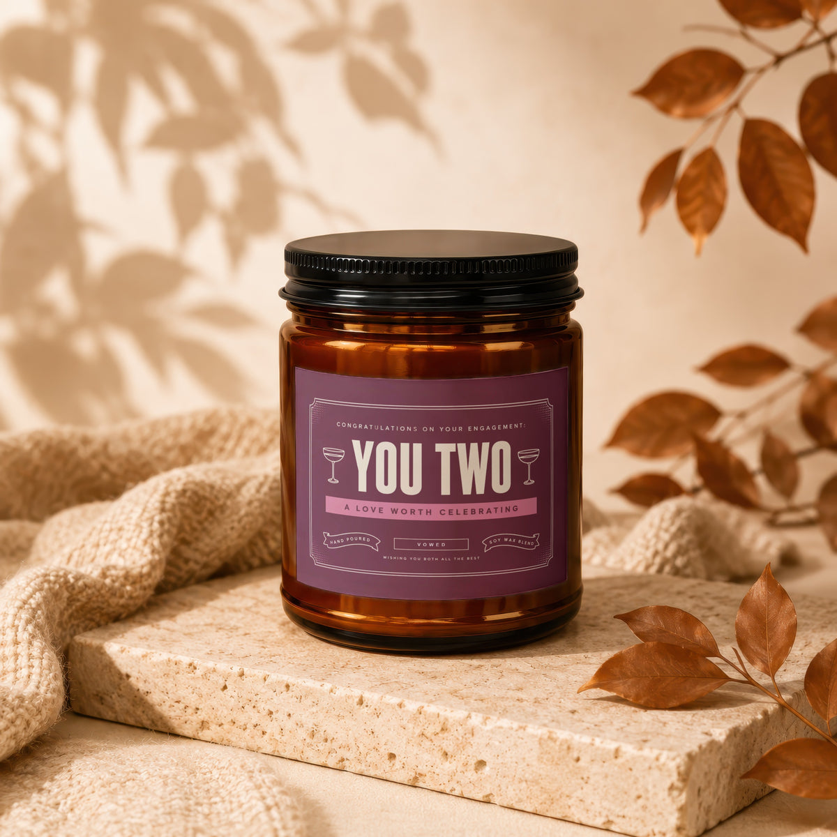 Amber candle with "YOU TWO A LOVE WORTH CELEBRATING" label.