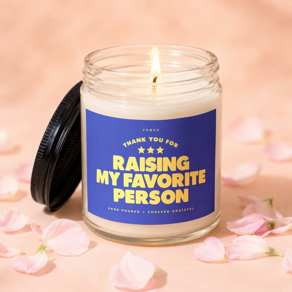 Candle with label "Thank you for raising my favorite person" on pink background