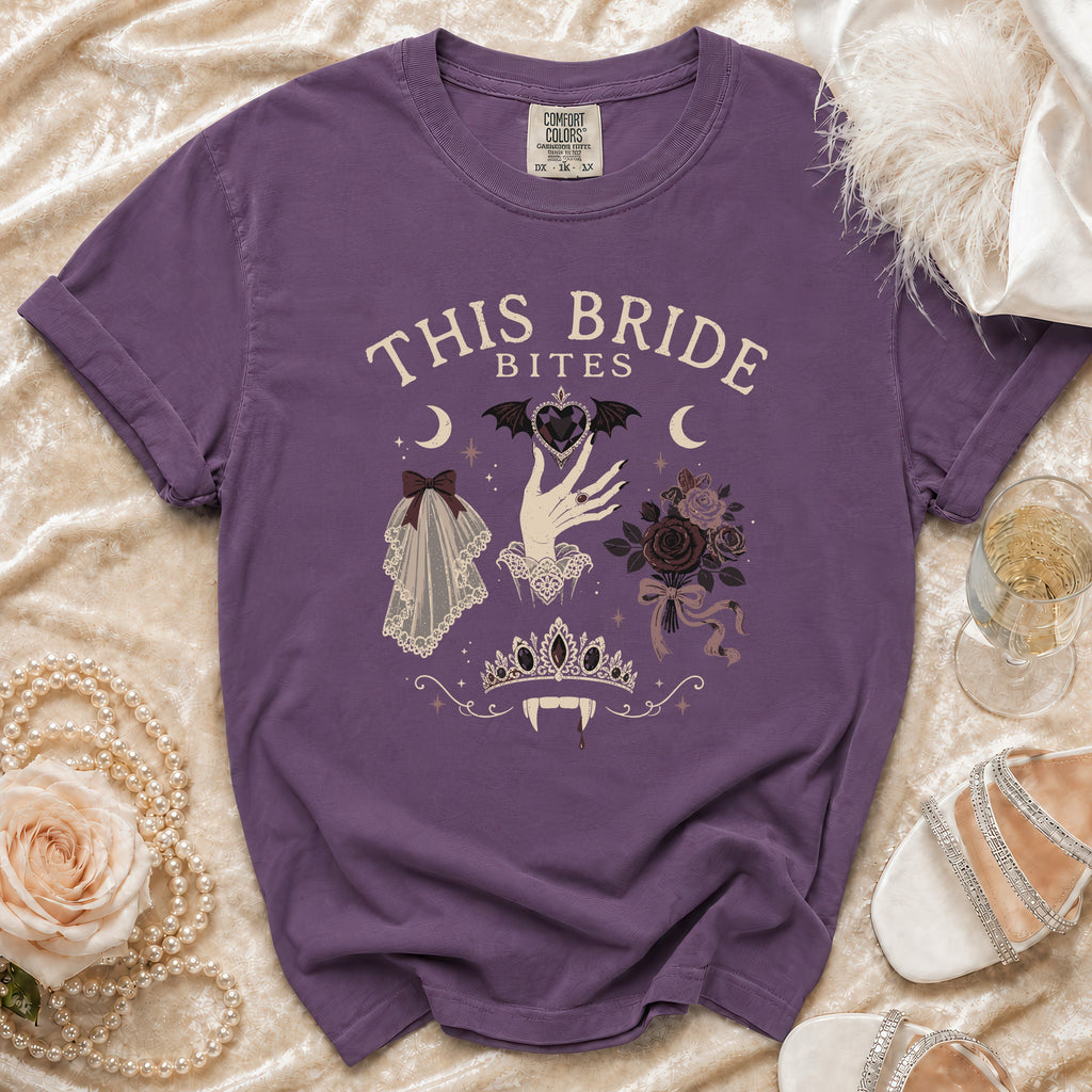 Purple t-shirt with "This Bride Bites" text and gothic bridal imagery.