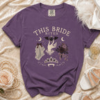Purple t-shirt with "This Bride Bites" text and gothic bridal imagery.