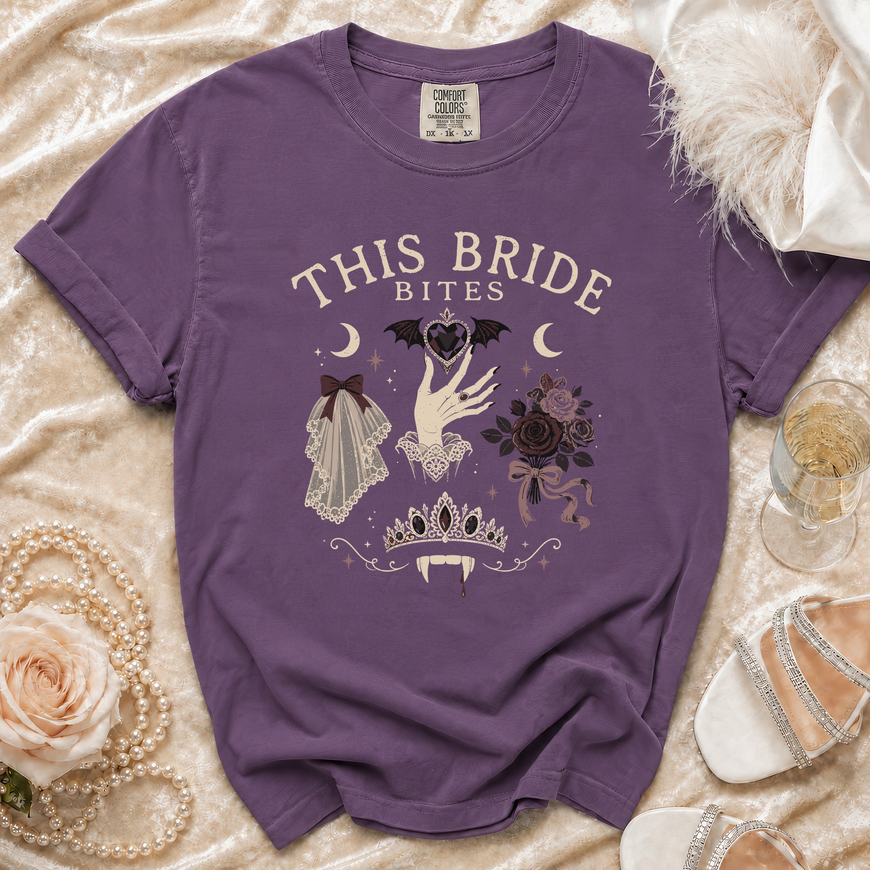 Purple t-shirt with "This Bride Bites" text and gothic bridal imagery.