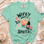 Mint t-shirt with "Wifey Wants a Spritz" text, cocktail, and wedding veil graphics.