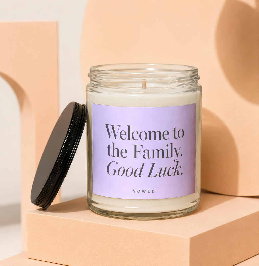 Candle with "Welcome to the Family. Good Luck." text on a pastel background.