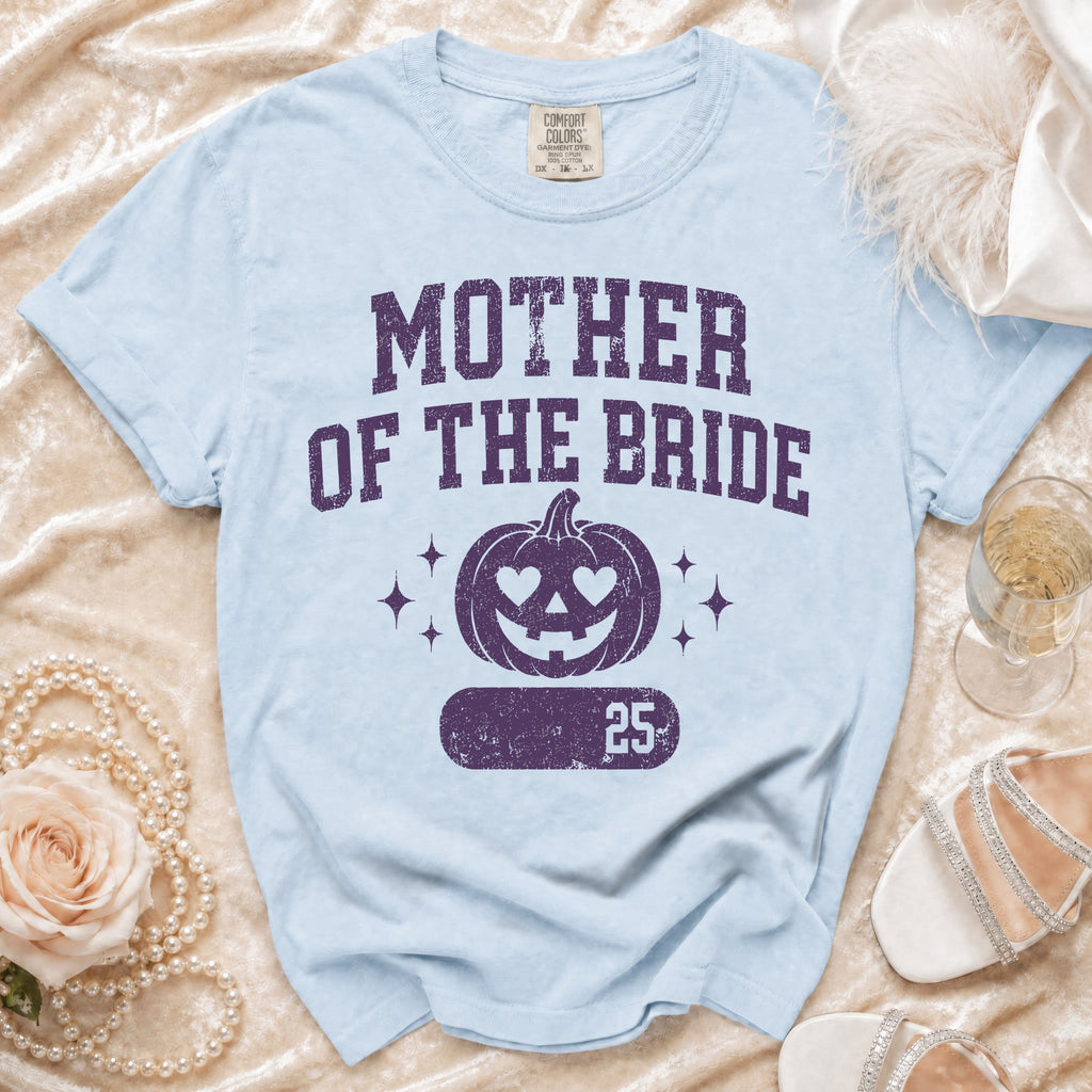 Light blue t-shirt with "Mother of the Bride" and jack-o'-lantern graphic.