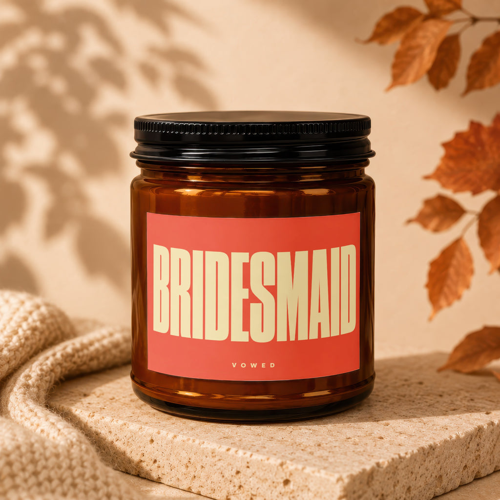 Amber jar candle with "BRIDESMAID" in large text on a coral label.