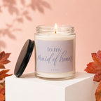 Candle with text "to my maid of honor" on label, with lid off.
