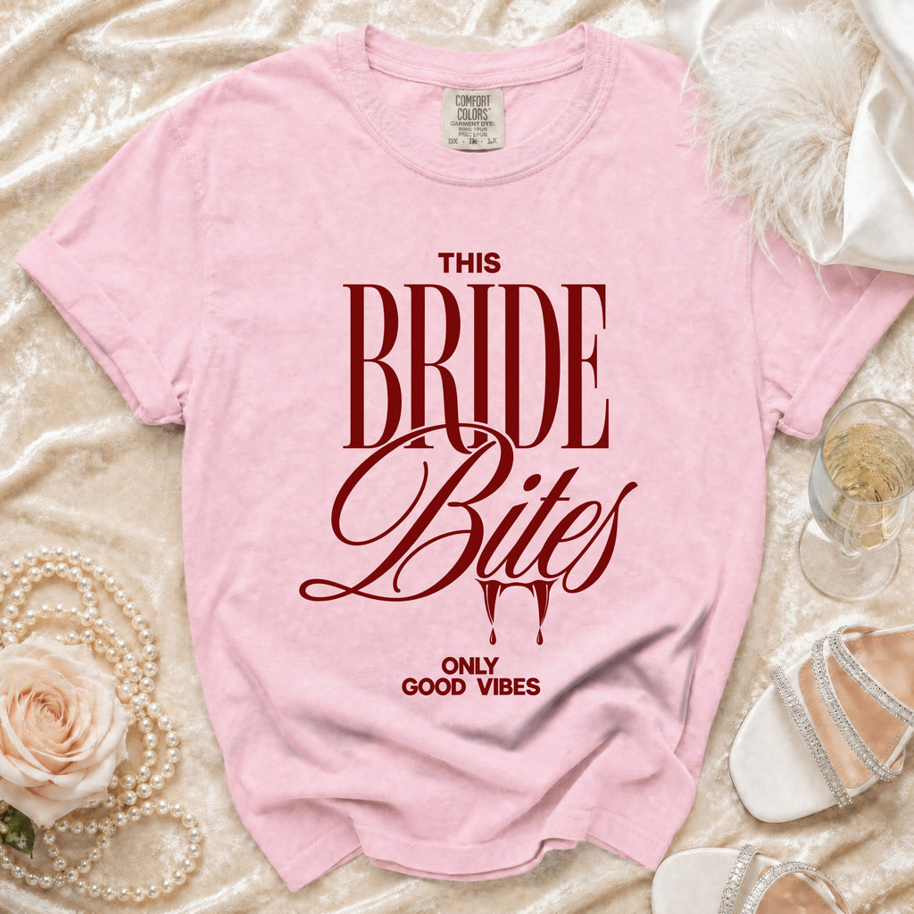 Pink t-shirt with "THIS BRIDE Bites" and "ONLY GOOD VIBES" text.