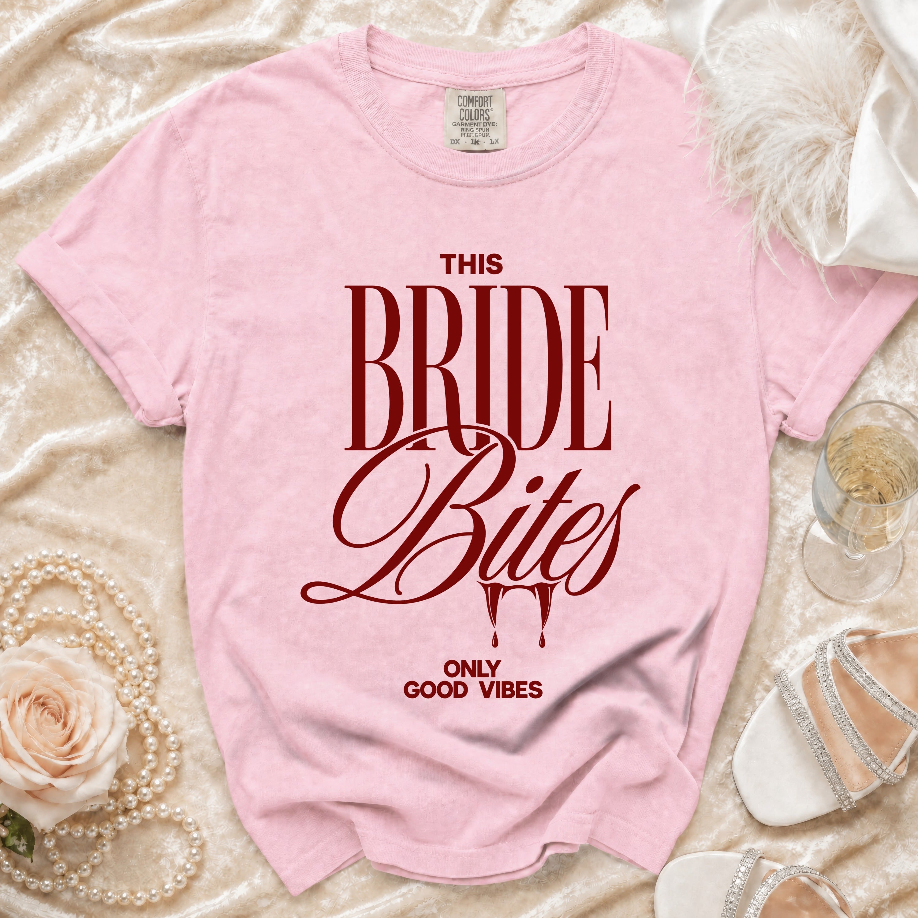 Pink t-shirt with "THIS BRIDE Bites" and "ONLY GOOD VIBES" text.