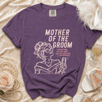 Purple t-shirt with "Mother of the Groom" and a woman holding champagne.