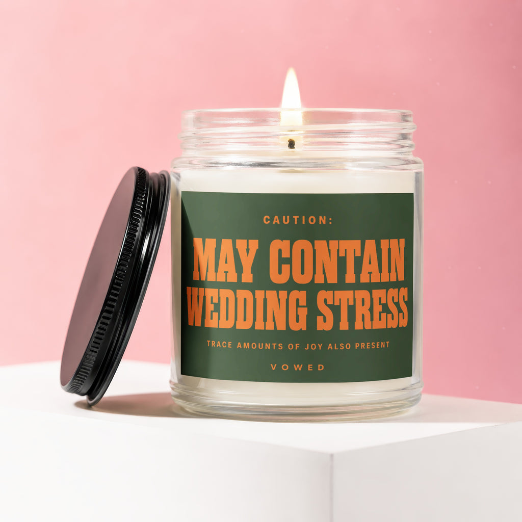 Candle with label reading "CAUTION: MAY CONTAIN WEDDING STRESS TRACE AMOUNTS OF JOY ALSO PRESENT".