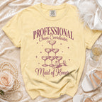 Yellow t-shirt with "PROFESSIONAL Chaos Coordinator Maid of Honor" and champagne glasses.
