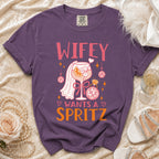 Purple t-shirt with graphic "Wifey Wants A Spritz," cocktail, disco balls, and ring.